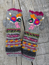 Load image into Gallery viewer, Grey handknitted wool fingerless mitts with bright embroidered flowers and textured knit details. Aster Fingerless Mitts, handmade in Nepal, fleece-lined.